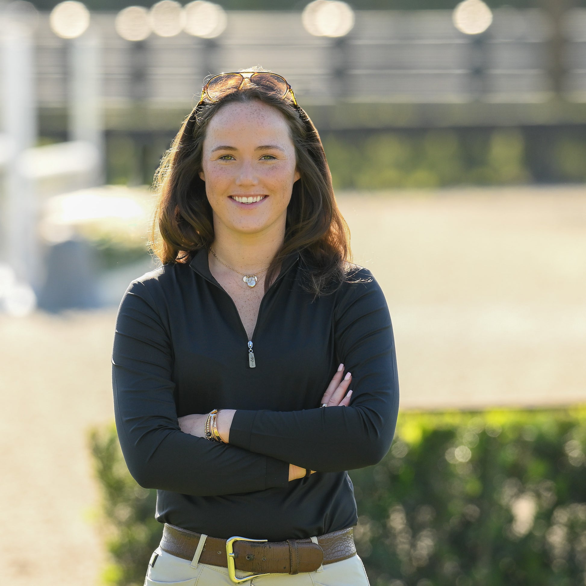 Young woman confidently posing in a Black Sun Shirt by EA Limited Inc., showcasing its stylish quarter-zip design and UPF 50+ sun protection rating.